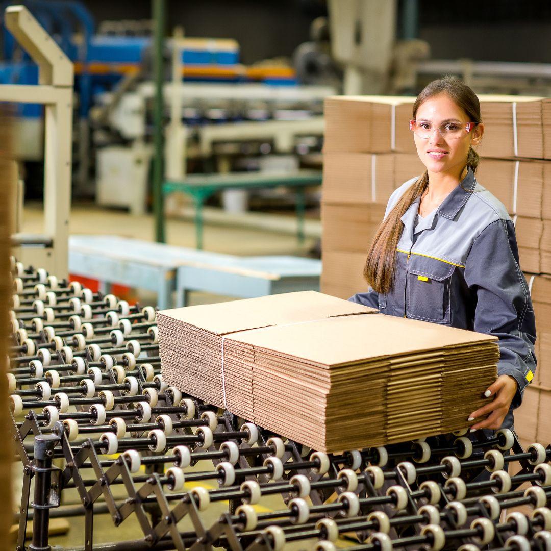 An Eco Tech Papers employee handling finished Kraft paper cartons
